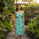 Young woman in a tropical hibiscus print dress made of green and white Islands Fabric polyester.