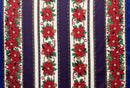 A festive holiday-themed polyester fabric featuring a repeating vertical stripe pattern. The design includes columns of vibrant red poinsettias and pine cones framed by delicate red ribbons, interspersed with deep navy blue panels decorated with subtle golden floral motifs and white background stripes.